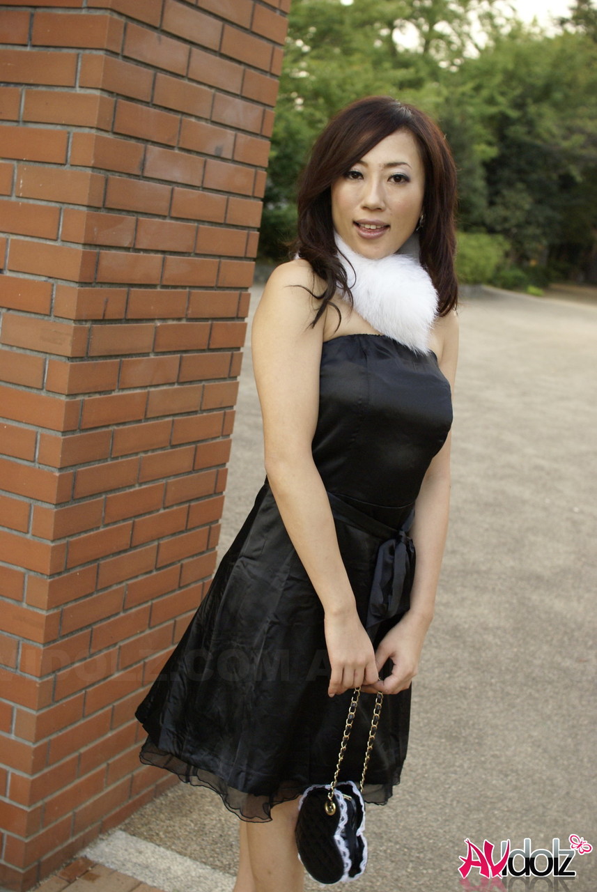 Japanese girl Yuki Motoyama models non nude in a black dress outdoors