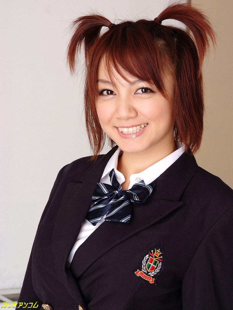 Japanese schoolgirl with pigtails Meguru Kosaka poses in her student uniform