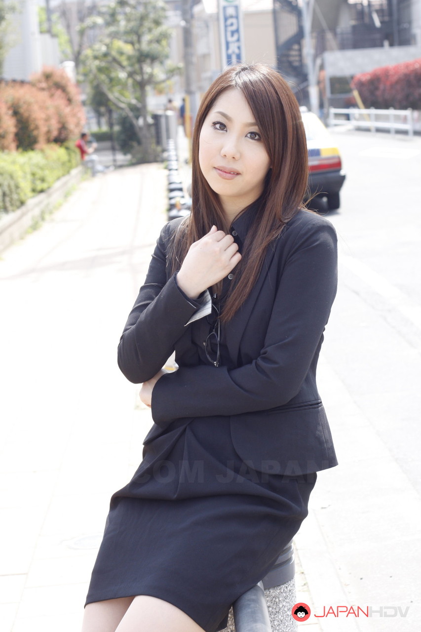 Japanese model Hikaru Matsu takes her glasses on and off in business clothing