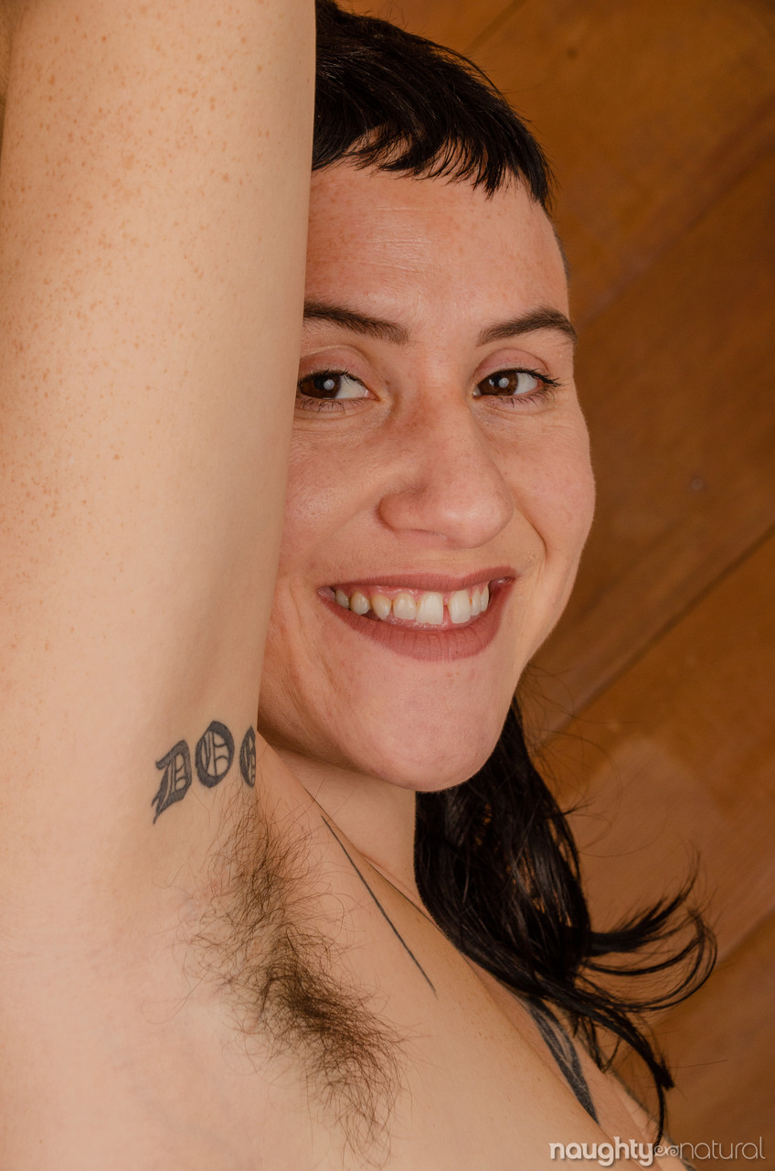 Amateur tattooed Esme Elliot doffs her dress & flaunts her hairy pits & pussy