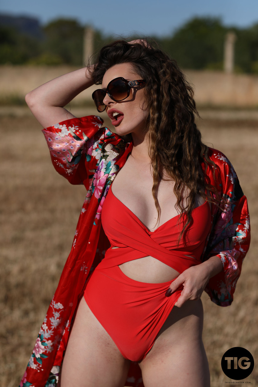 Curly haired babe Valis Volkova removes her red bikini and poses outdoors